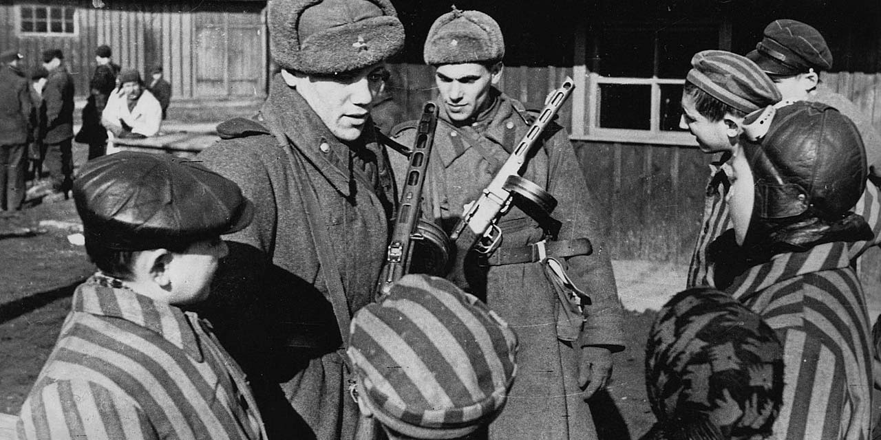 Soviet Army soldiers chatting to the children just liberated from the Auschwitz concentration camp